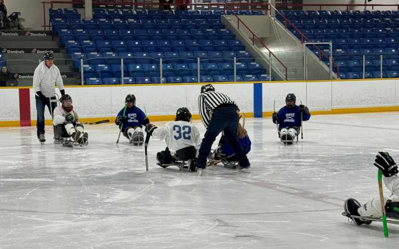 6 sledge hockey players during a face off